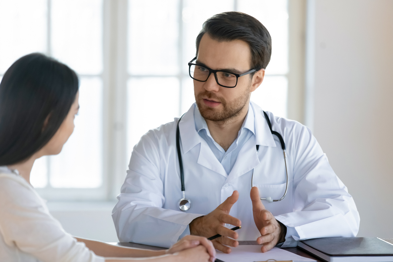 Male GP talk at consultation with female client